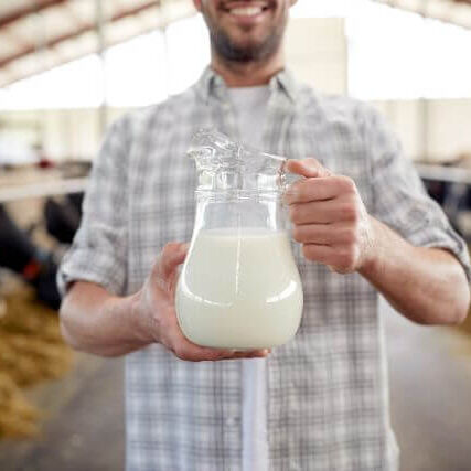 holding pitcher of milk